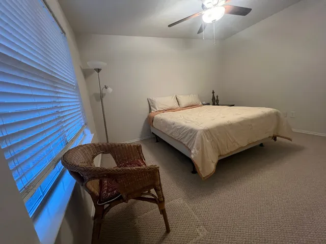 a bedroom with bed and a chandelier