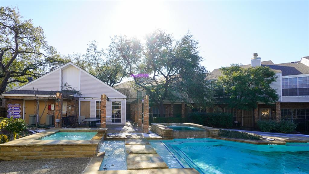 View of swimming pool featuring an in-ground hot tub and patio surround