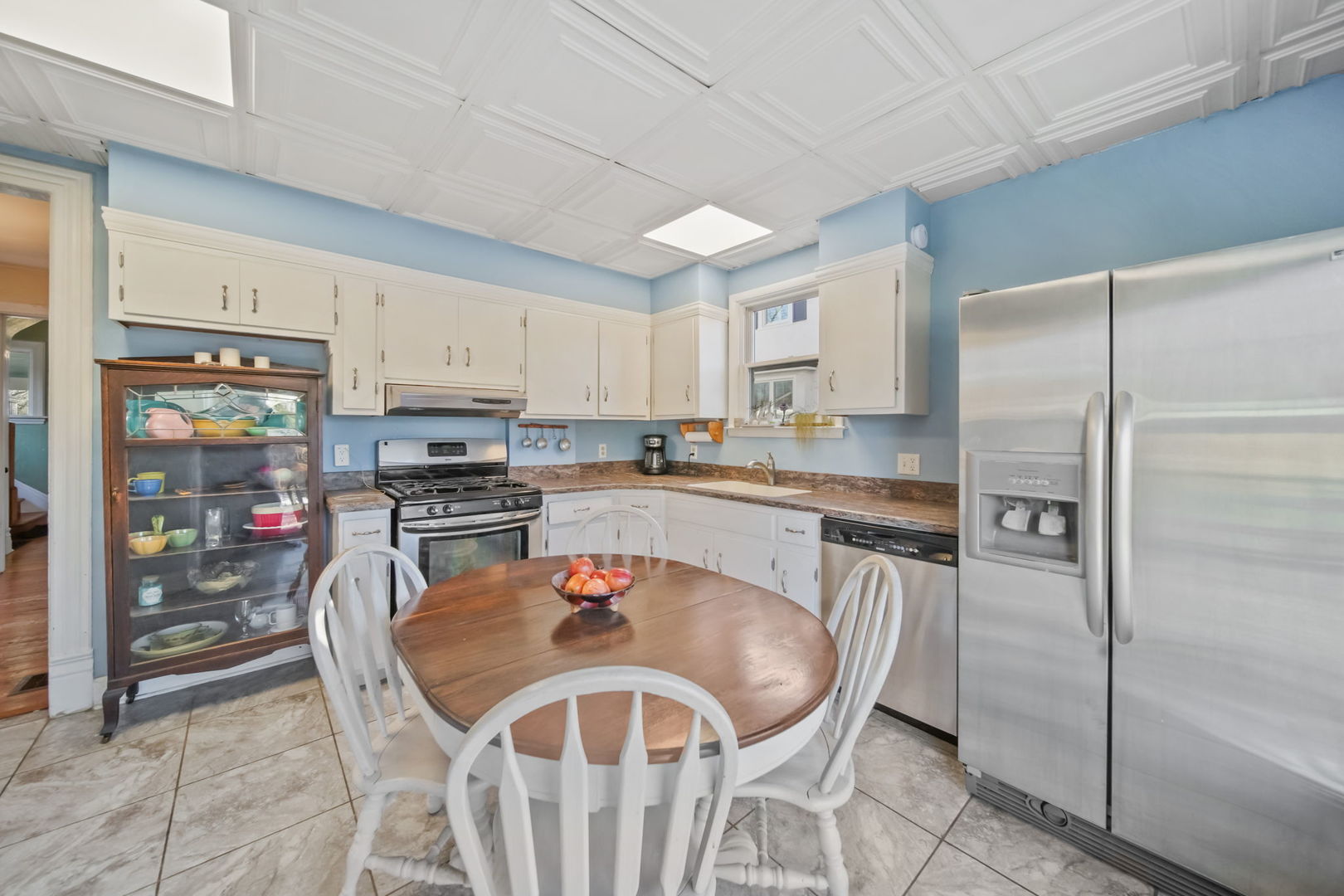 4142 Wolf Road Western Springs, IL 60558 - Photo 11 of 34 a kitchen with stainless steel appliances granite countertop a refrigerator a sink a stove a dining table and chairs