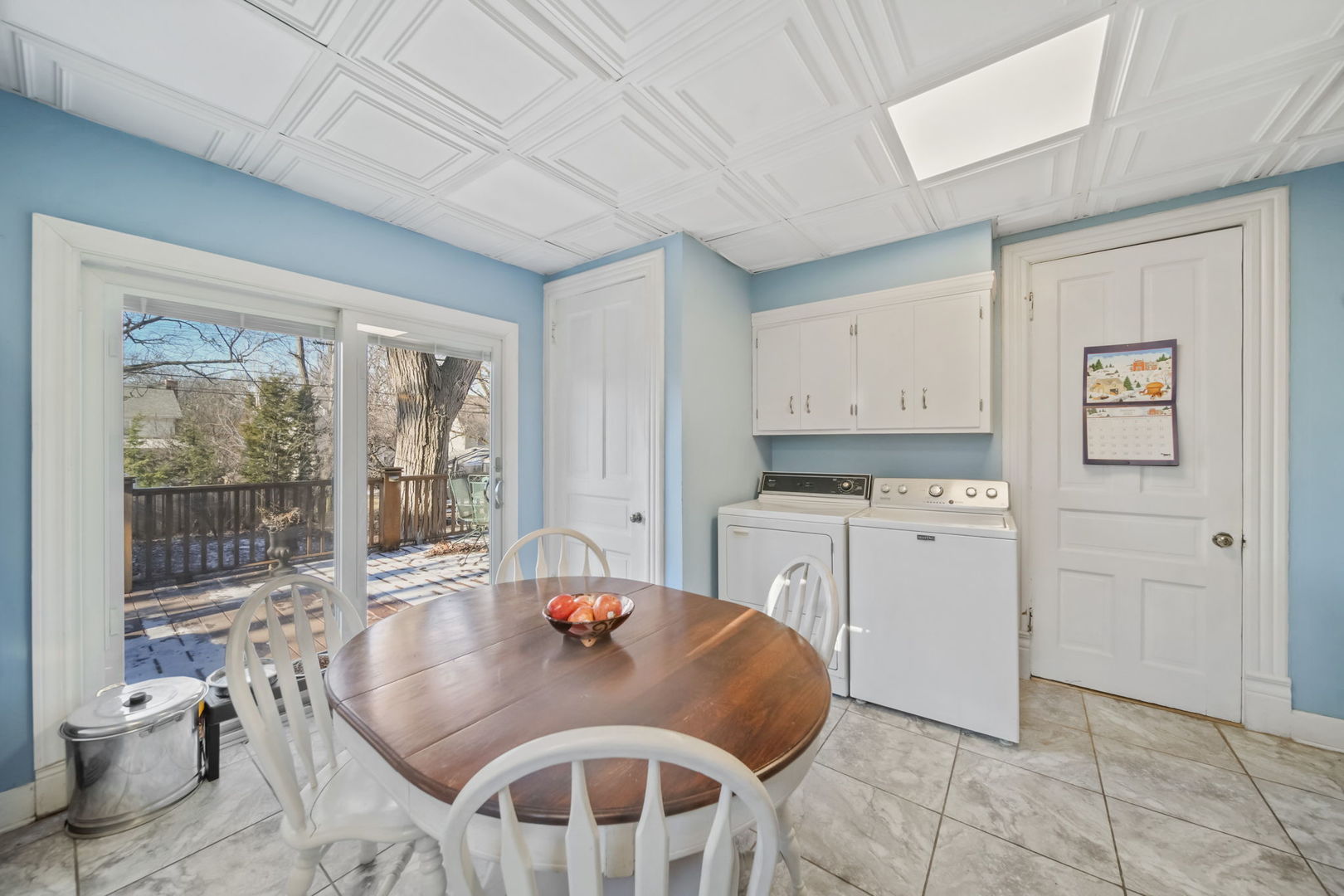 4142 Wolf Road Western Springs, IL 60558 - Photo 13 of 34 a open kitchen with a stove a refrigerator a sink dishwasher with a dining table and chairs