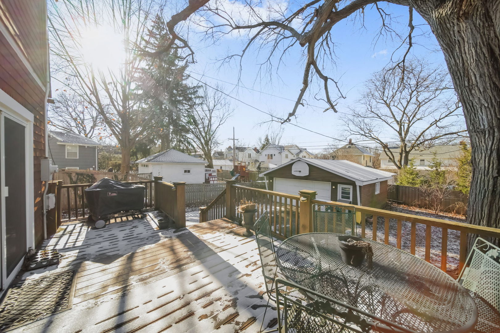 4142 Wolf Road Western Springs, IL 60558 - Photo 23 of 34 a view of a house with a wooden bench next to a building