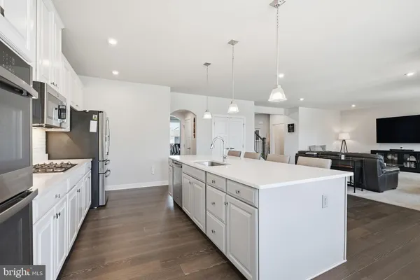 a kitchen with sink stove and microwave