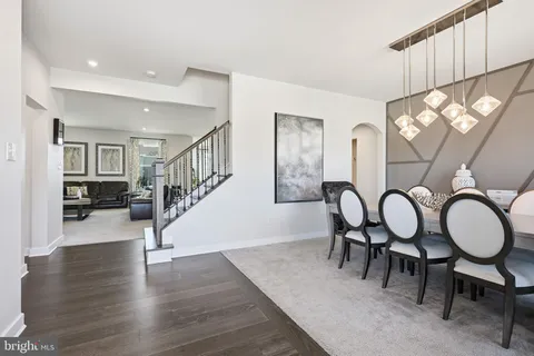 a view of a workspace room with furniture and window