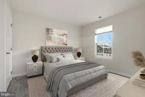 a bedroom with a bed and a couch