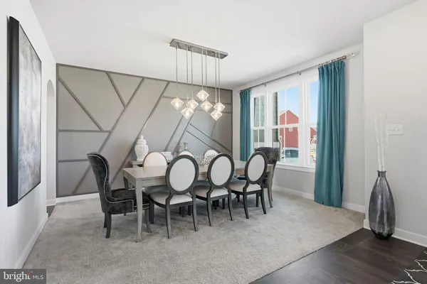 a dining room with furniture and window