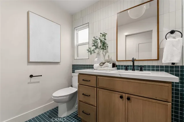 a bedroom with a bed and a lamp on the dresser