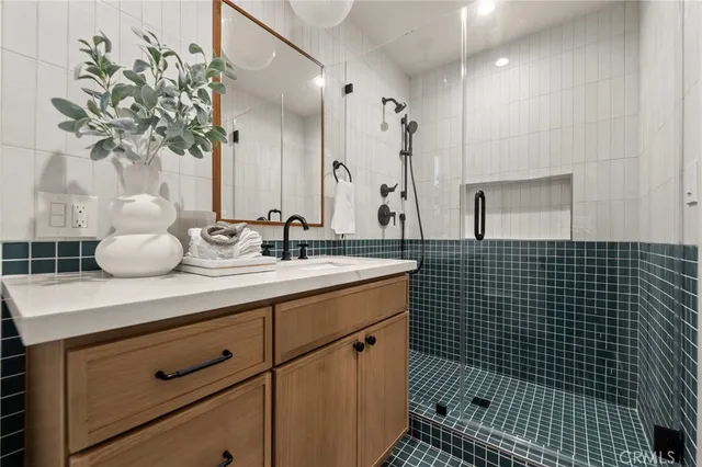 a bathroom with a double vanity sink a toilet and a mirror