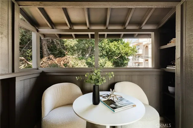 a view of a patio with couches and a table and chairs with garden view