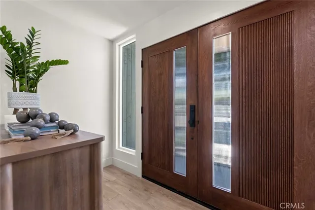 a living room with furniture a fireplace and a floor to ceiling window