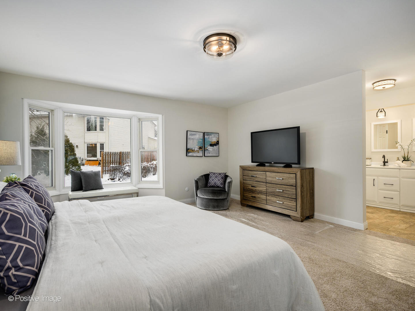526 Thomas Road Bolingbrook, IL 60440 - Photo 14 of 23 a bedroom with a bed and a flat tv screen on wall