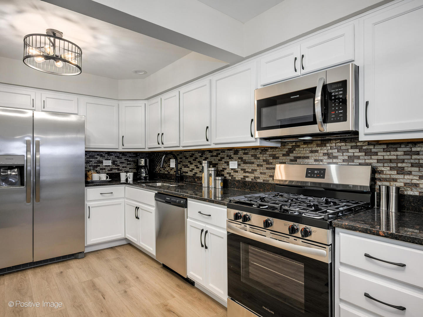 526 Thomas Road Bolingbrook, IL 60440 - Photo 9 of 23 a kitchen with stainless steel appliances granite countertop a stove a refrigerator and a microwave