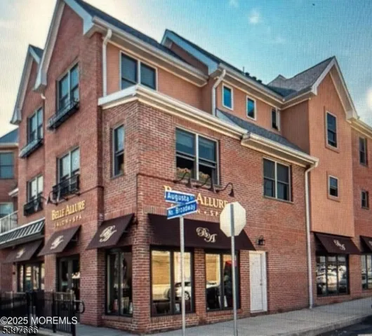 a front view of a residential apartment building with a yard