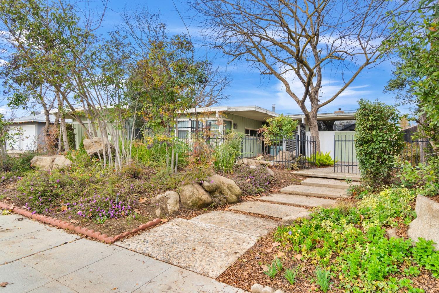 a front view of a house with a garden