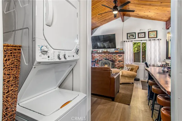 a living room with furniture a flat screen tv and a table