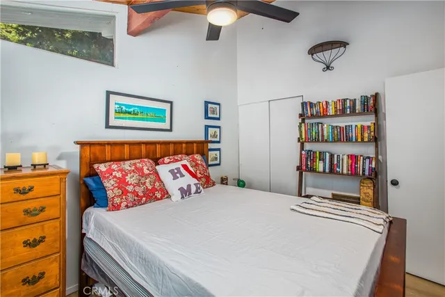 a bedroom with a bed and a book shelf