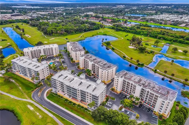 an aerial view of a house with outdoor seating