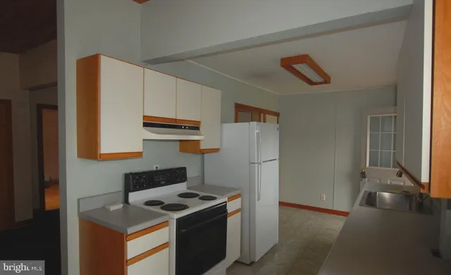 a kitchen with a stove and a refrigerator