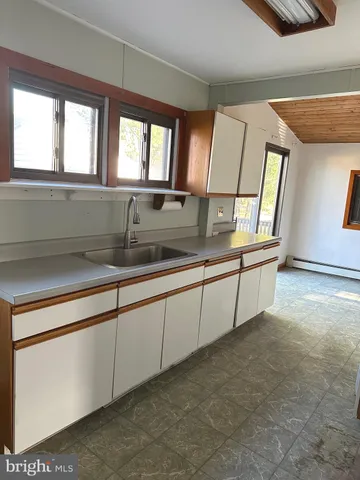 a view of a kitchen with a sink and window
