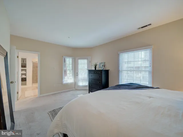 a bedroom with a large bed and a window