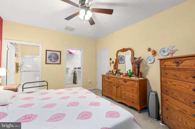 a living room with furniture a dining table and a chandelier