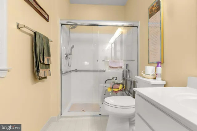 a bathroom with a granite countertop sink a toilet and a mirror