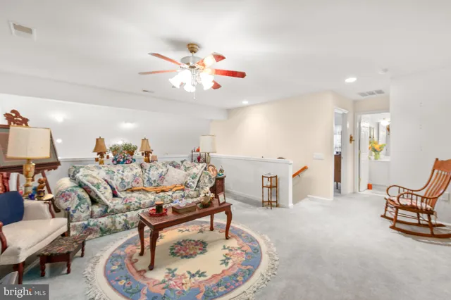 a living room with furniture gym equipment and a window