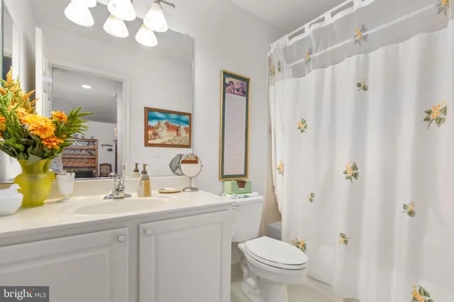 a spacious bedroom with a bed and a chandelier