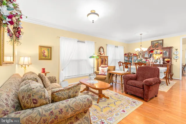 a living room with lots of furniture and a wooden floor