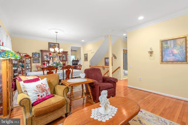 a view of a dining room with furniture and a chandelier