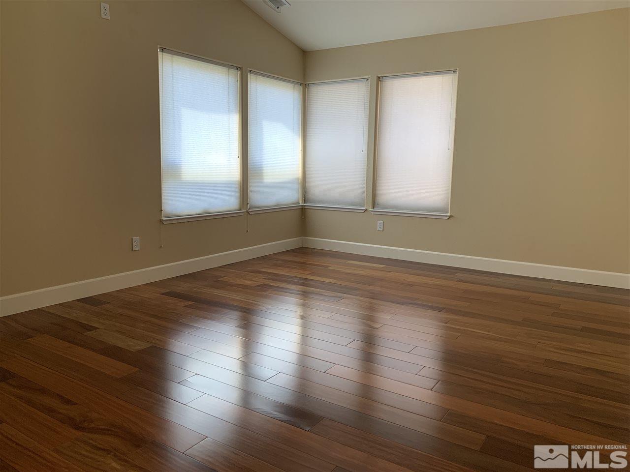 3126 Alpine Creek Road Reno, NV 89519 - Photo 13 of 25 a view of an empty room with wooden floor and a window