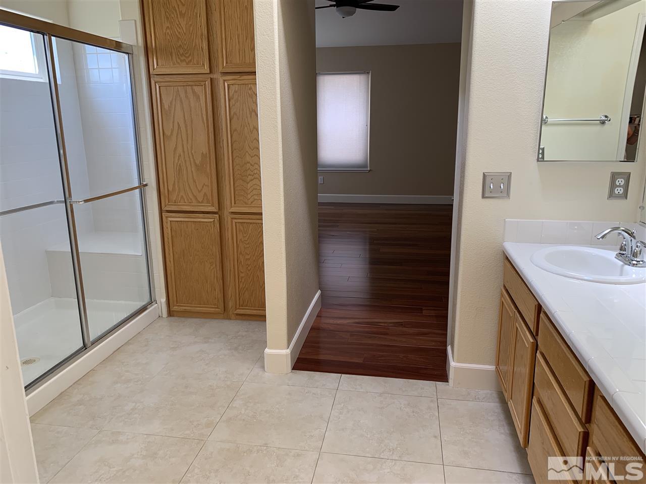 3126 Alpine Creek Road Reno, NV 89519 - Photo 14 of 25 a bathroom with a sink and a mirror