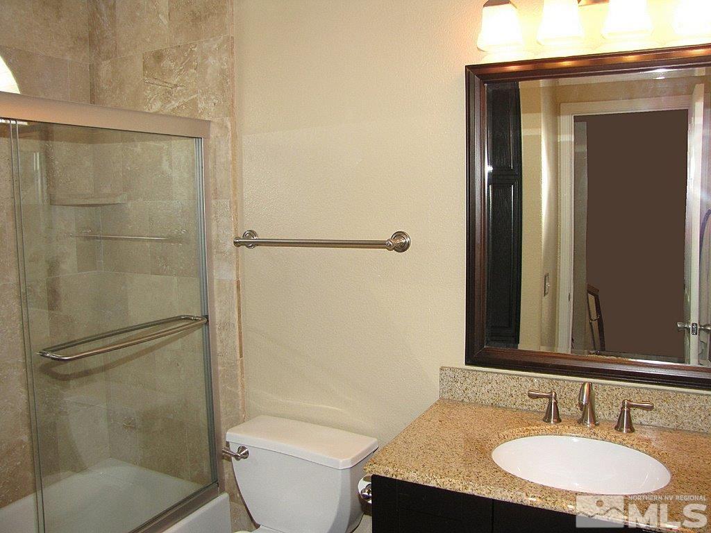 3126 Alpine Creek Road Reno, NV 89519 - Photo 20 of 25 a bathroom with a granite countertop sink toilet and shower