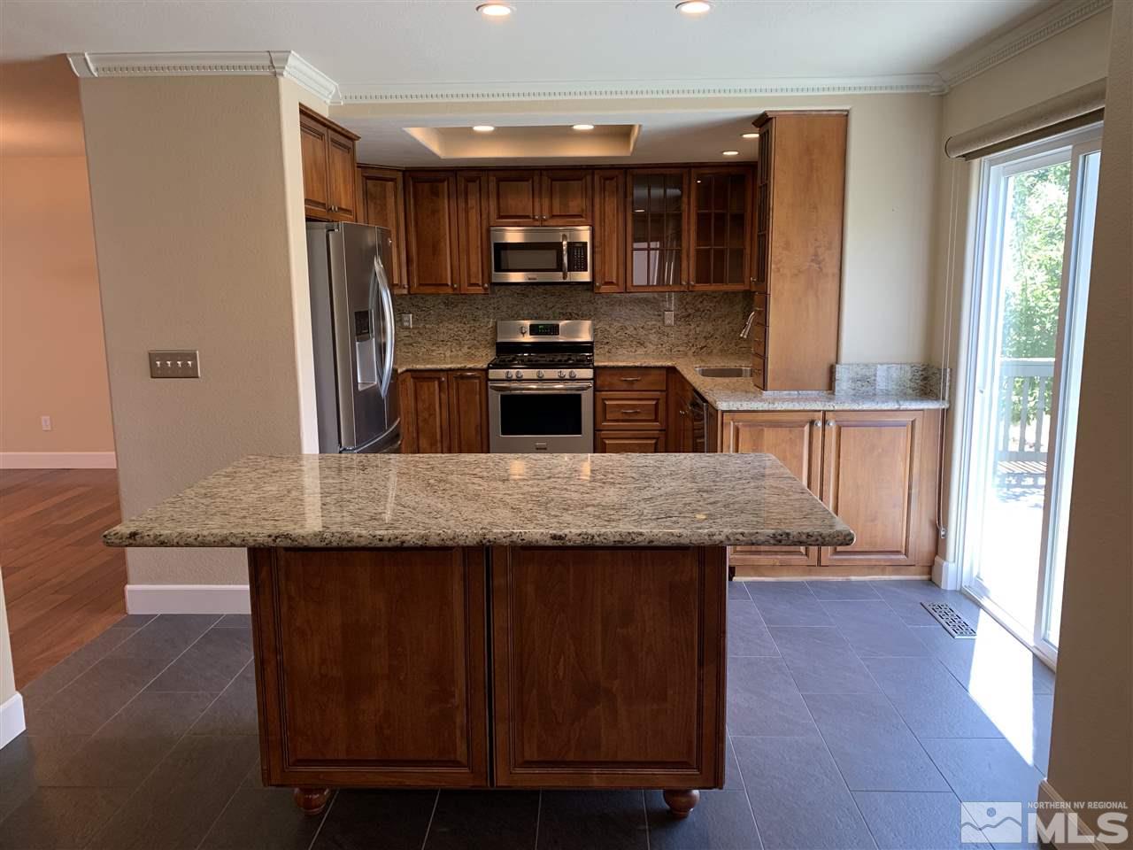 3126 Alpine Creek Road Reno, NV 89519 - Photo 7 of 25 a kitchen with stainless steel appliances granite countertop a stove a sink and a refrigerator