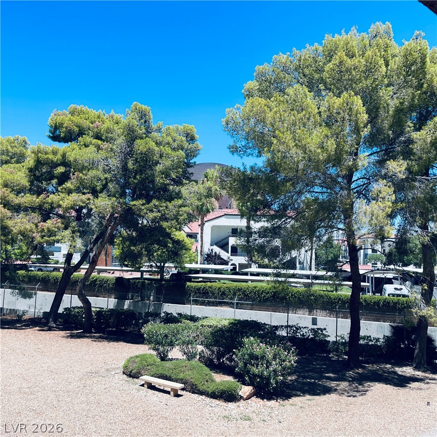 260 East Flamingo Road, Unit 118 Las Vegas, NV 89169 - Photo 1 of 9 A tranquil outdoor space offers a natural bench, ideal for enjoying serene surroundings.