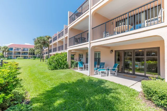 a view of a house with a yard porch and sitting area