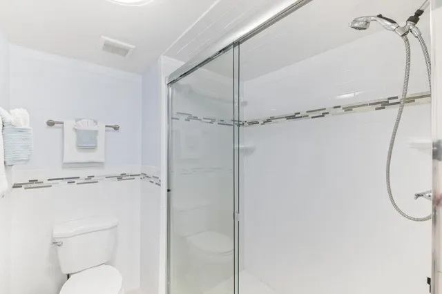 a bathroom with a shower a toilet and a sink