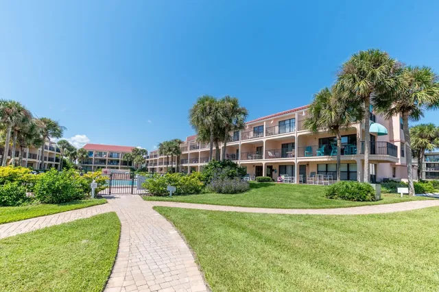 a front view of a building with a garden