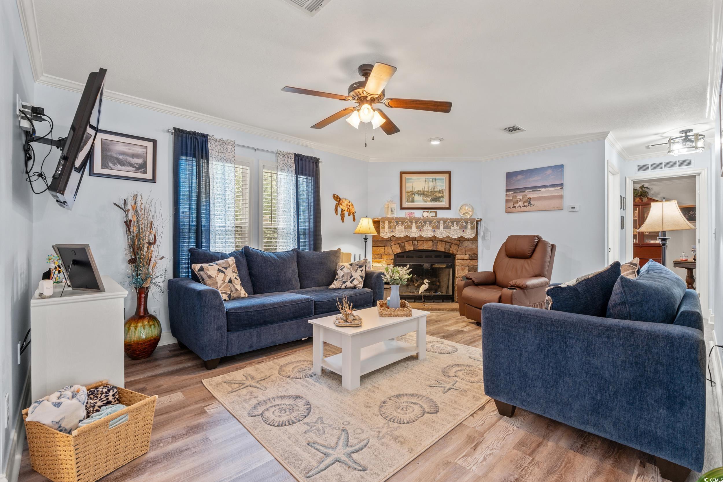 90 Offshore Drive Murrells Inlet, SC 29576 - Photo 7 of 40 Living room featuring a fireplace, ornamental molding, wood finished floors, and ceiling fan