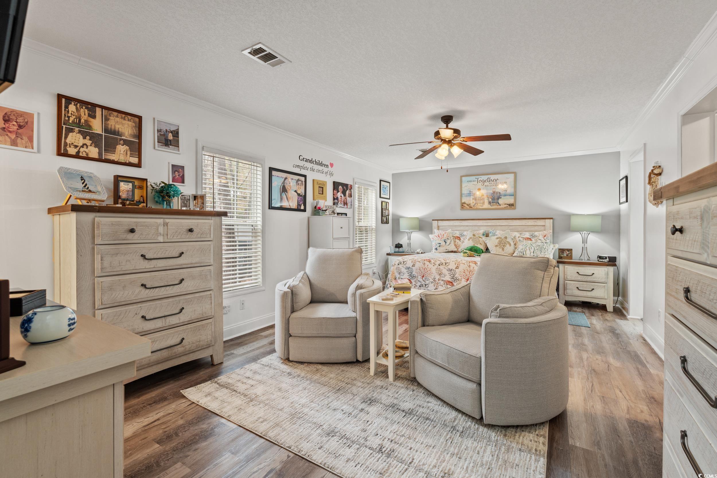 90 Offshore Drive Murrells Inlet, SC 29576 - Photo 11 of 40 Bedroom with crown molding, wood finished floors, ceiling fan, and a textured ceiling