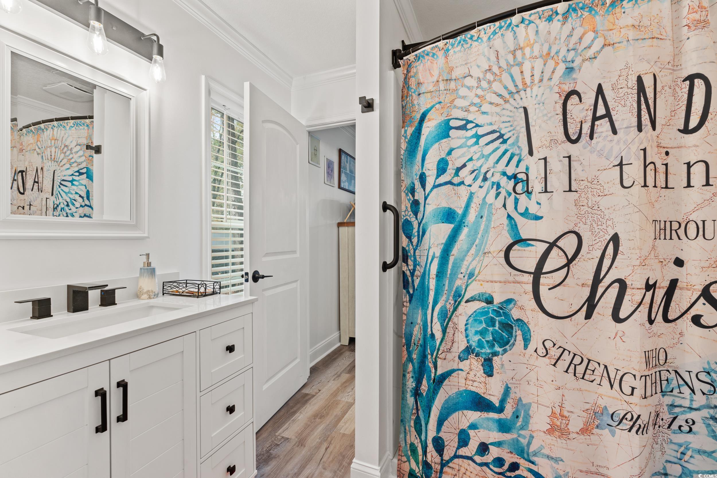 90 Offshore Drive Murrells Inlet, SC 29576 - Photo 15 of 40 Bathroom with vanity, curtained shower, crown molding, and light wood-style flooring