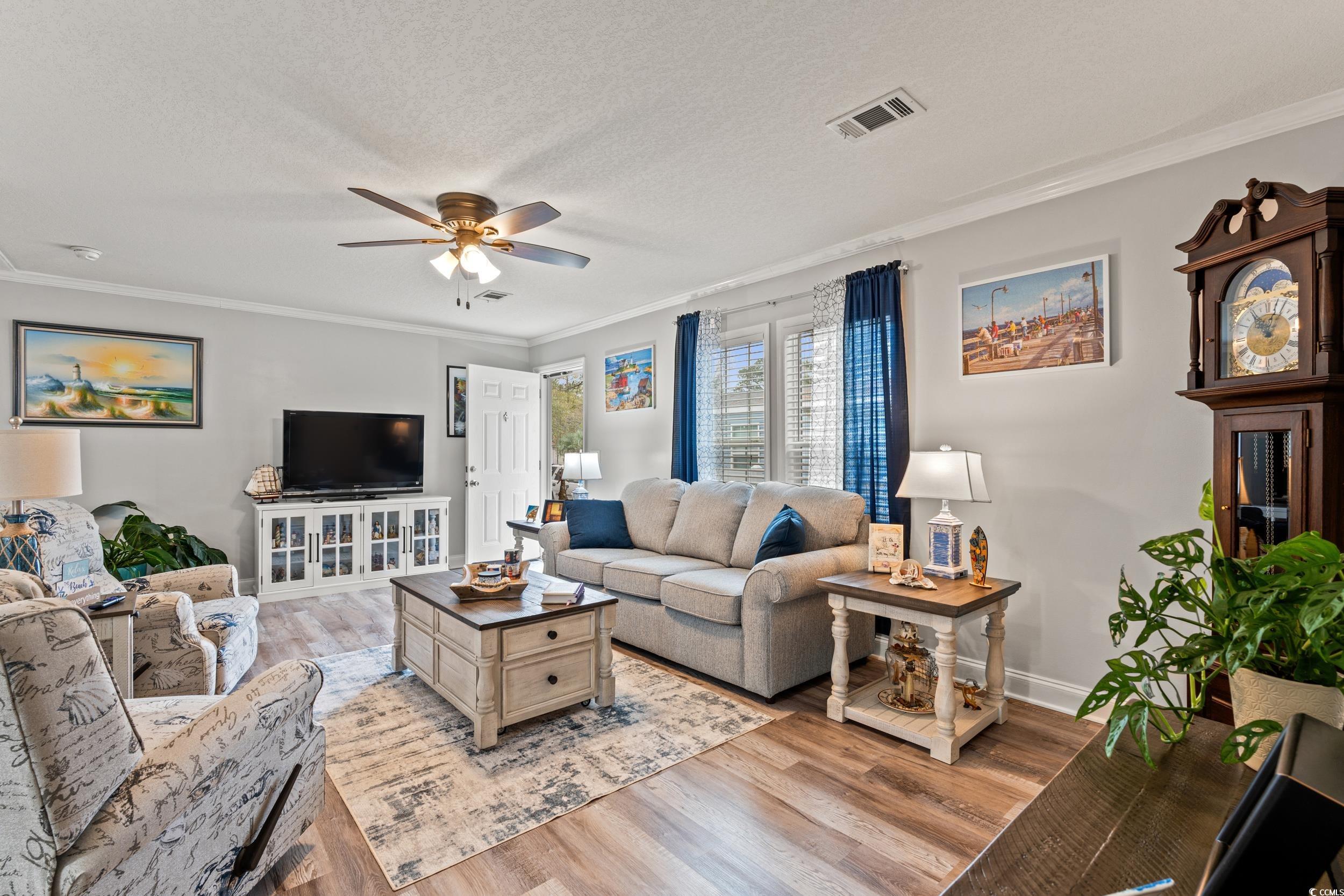 90 Offshore Drive Murrells Inlet, SC 29576 - Photo 2 of 40 Living area featuring ornamental molding, wood finished floors, a ceiling fan, and a textured ceiling