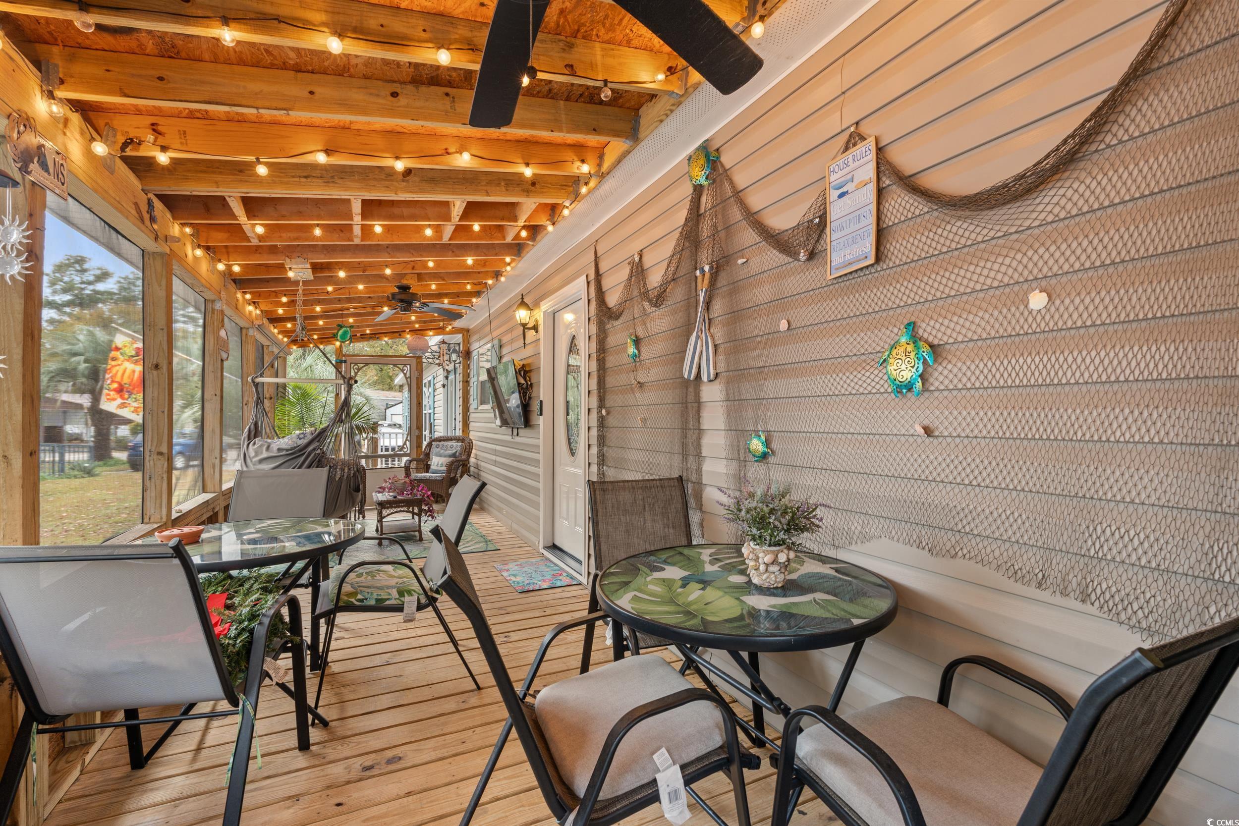 90 Offshore Drive Murrells Inlet, SC 29576 - Photo 25 of 40 Sunroom / solarium with outdoor dining area, ceiling fan, beamed ceiling, and a wooden deck