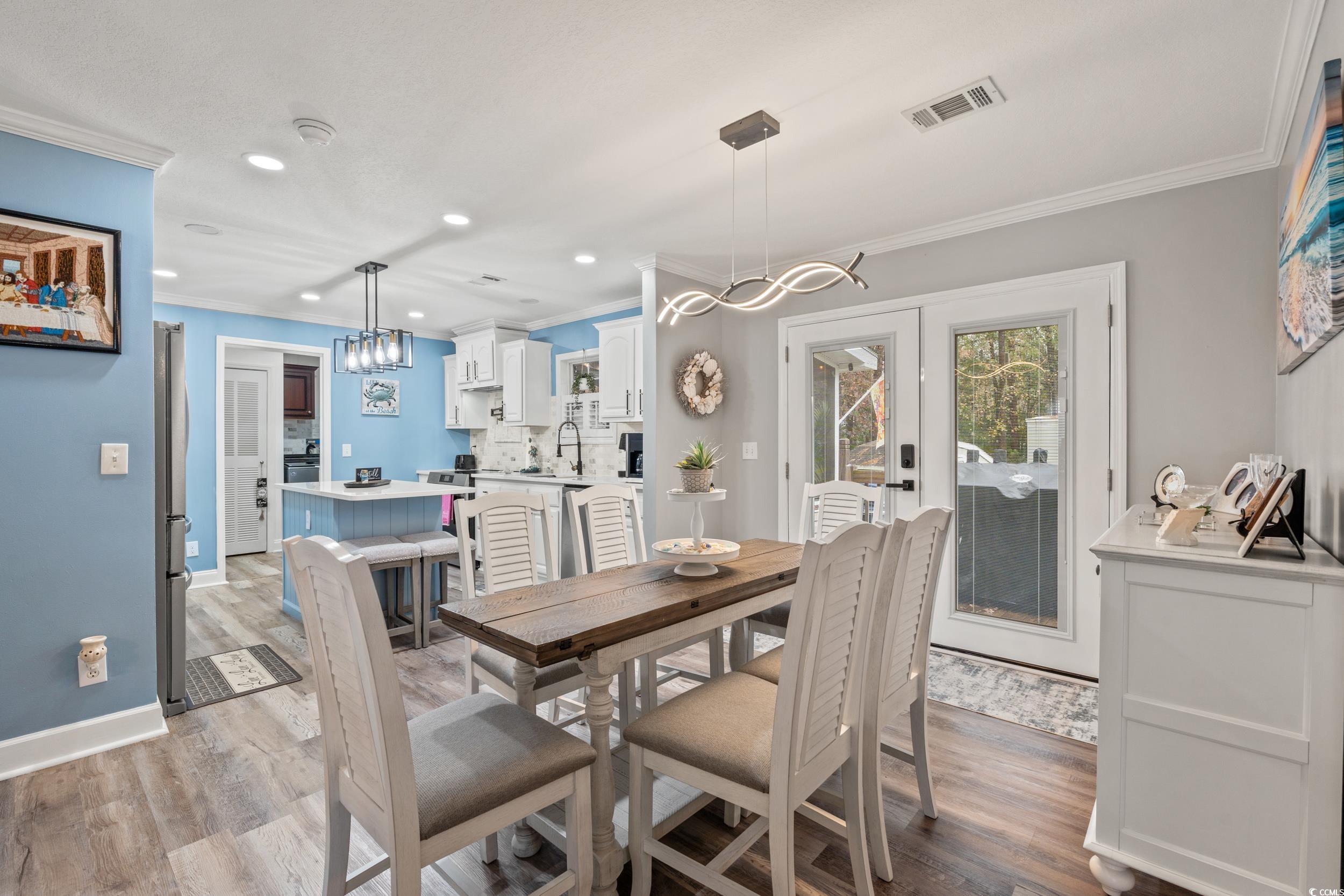 90 Offshore Drive Murrells Inlet, SC 29576 - Photo 5 of 40 Dining room featuring french doors, a chandelier, light wood-style floors, ornamental molding, and recessed lighting
