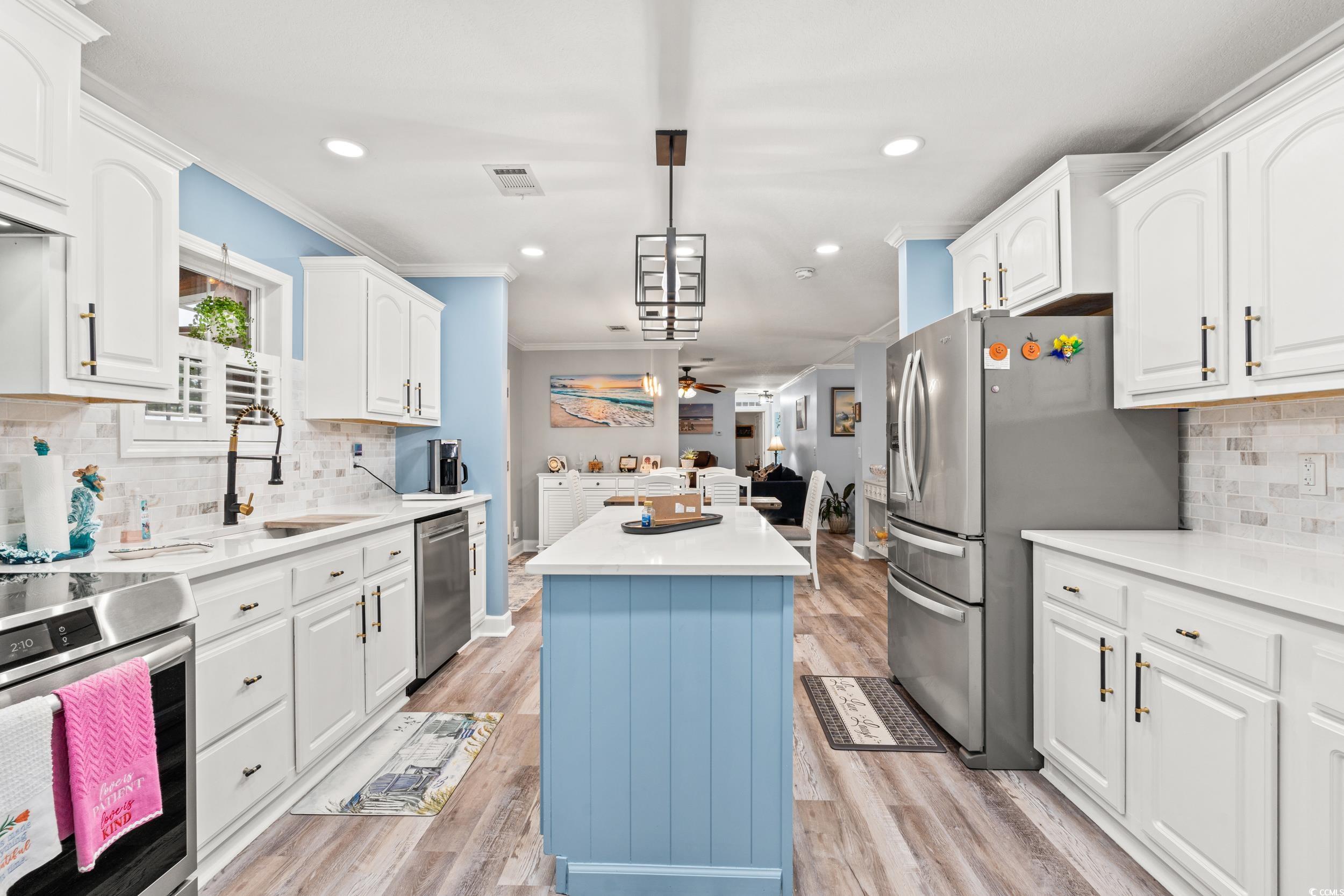 90 Offshore Drive Murrells Inlet, SC 29576 - Photo 39 of 40 Kitchen with decorative backsplash, open floor plan, recessed lighting, decorative light fixtures, and white cabinetry