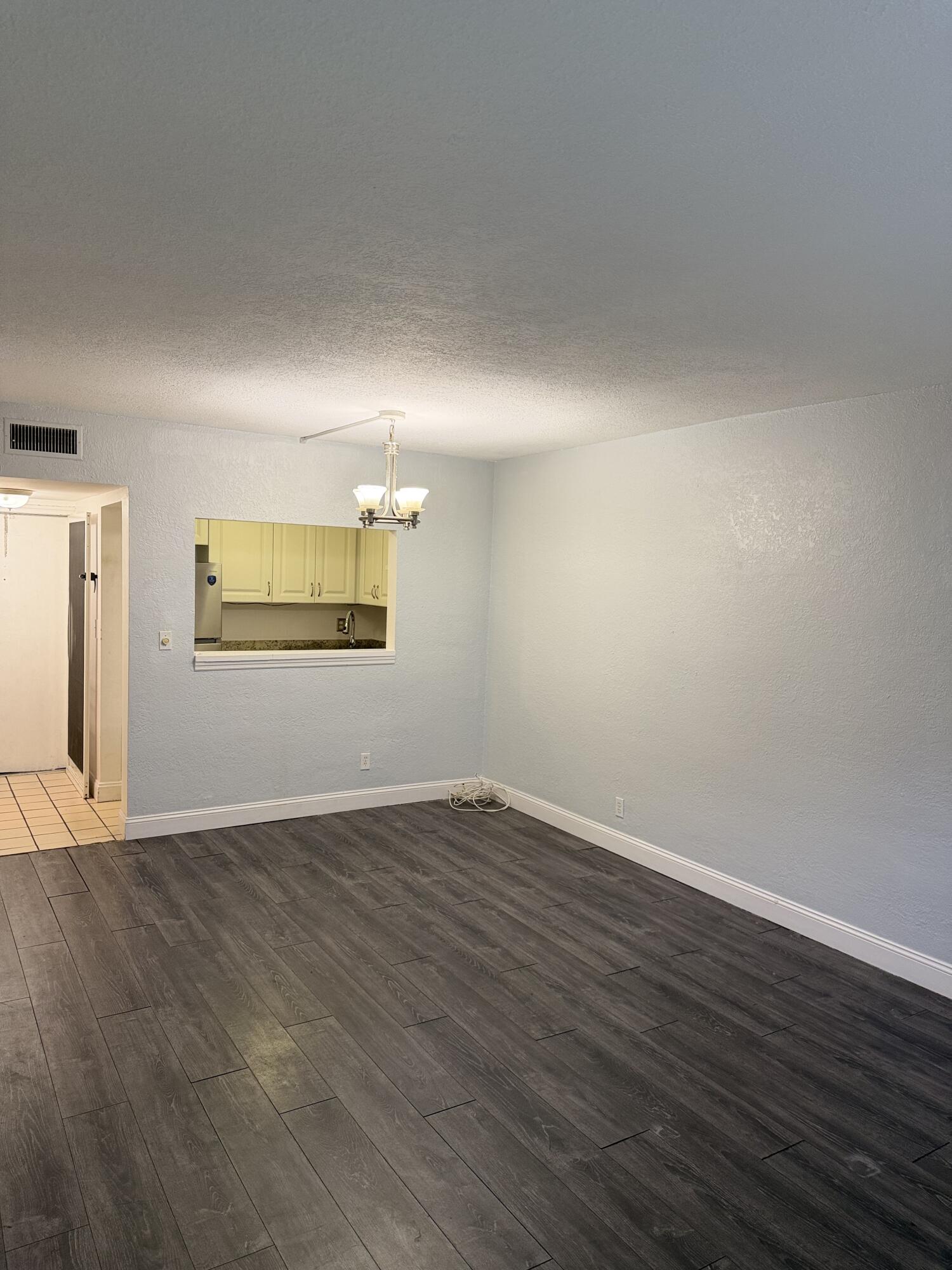 270 South Cypress Road, Unit 204 Pompano Beach, FL 33060 - Photo 4 of 14 a view of an empty room with wooden floor and a window