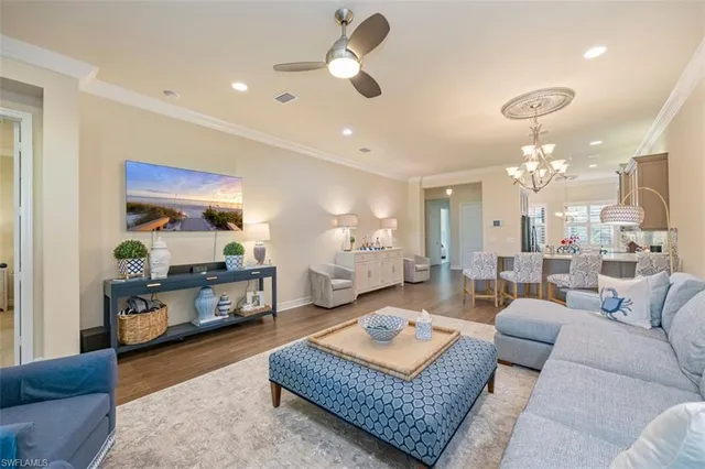 a living room with furniture and a chandelier
