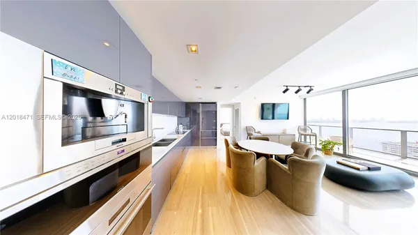 a large white kitchen with a large window