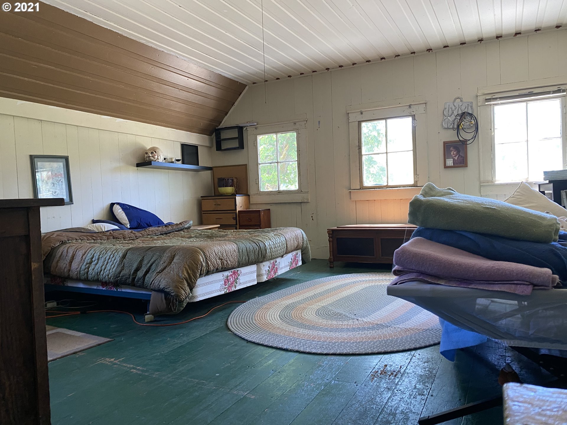 4189 Upper Olalla Road Winston, OR 97496 - Photo 32 of 32 a bedroom with a bed and wooden floor
