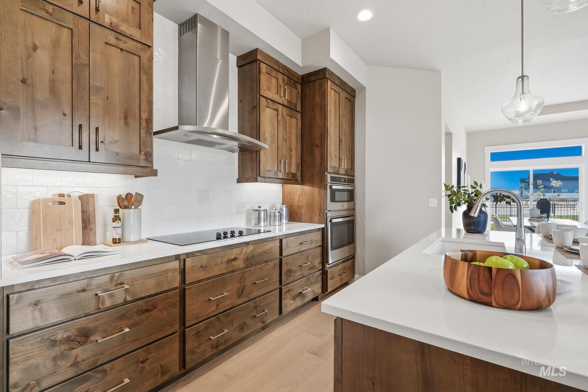 470 South Radiator Way Boise, ID 83716 - Photo 24 of 50 Kitchen featuring wood-finish cabinetry, stainless steel appliances, and light countertops