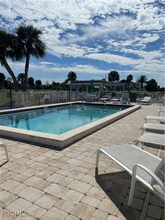 a view of swimming pool with outdoor seating and city view